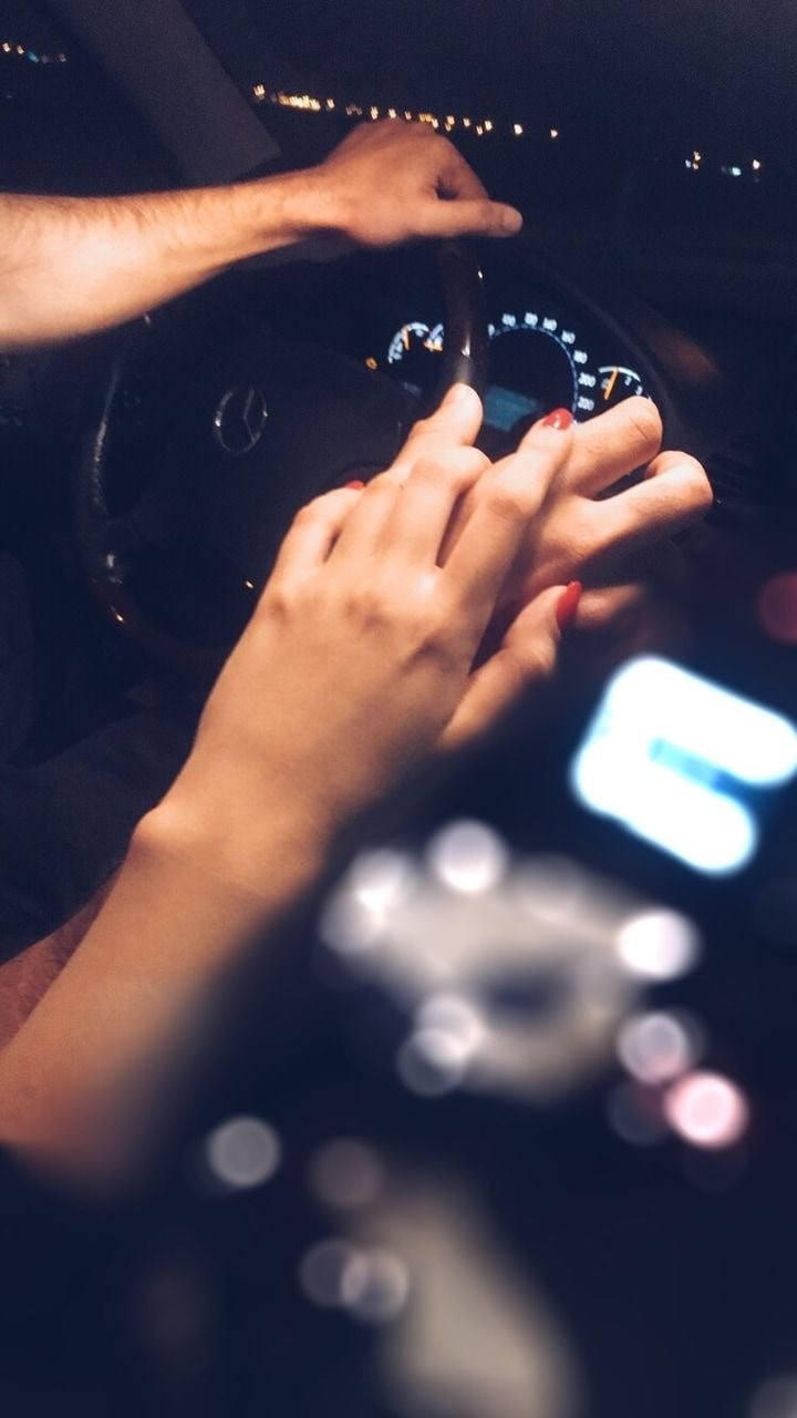 Couple Hands On Steering Wheel